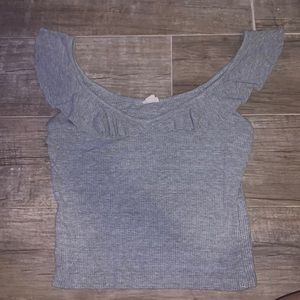 Grey top with “ruffles”. Possible off the shoulder